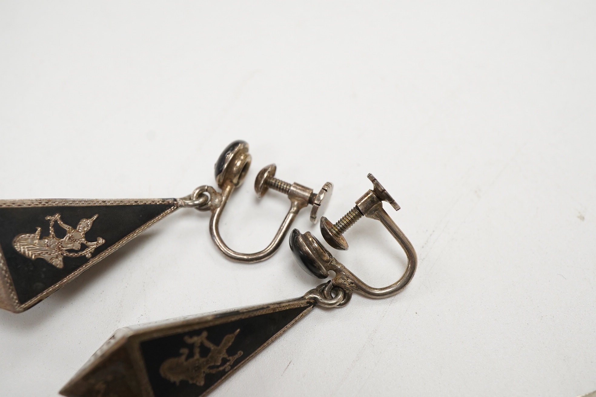 A Thai sterling and niello bracelet, 16.2cm, together with a pair of similar earrings.